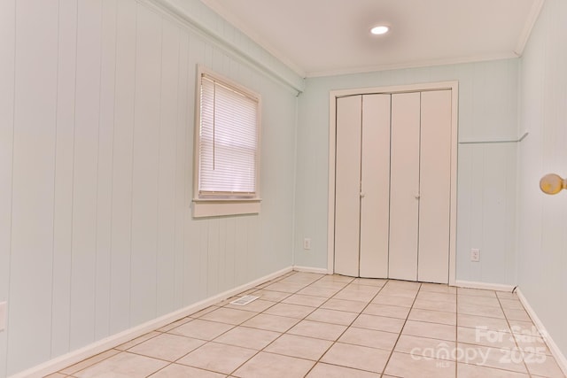 102 Lake Dr, Hickory, NC 28601 - unfurnished bedroom featuring ornamental molding, light tile patterned flooring, a closet, and baseboards