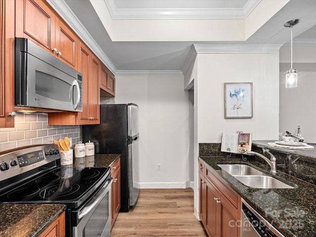 300 W 5th St Unit 433, Charlotte, NC 28202 - kitchen featuring appliances with stainless steel finishes, a sink, brown cabinetry, a raised ceiling, and light wood-style flooring