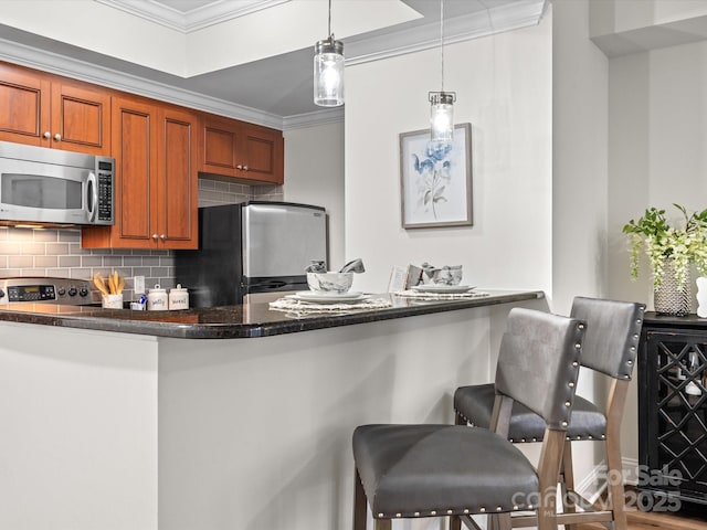 300 W 5th St Unit 433, Charlotte, NC 28202 - kitchen with stainless steel appliances, ornamental molding, backsplash, brown cabinets, and decorative light fixtures