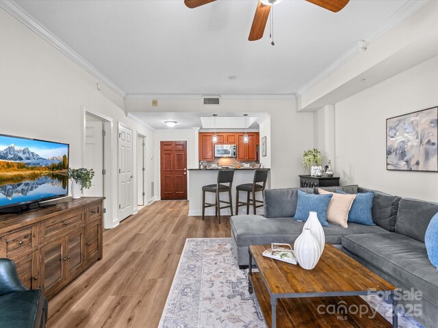 300 W 5th St Unit 433, Charlotte, NC 28202 - living area with light wood-style floors, crown molding, and a ceiling fan