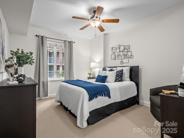 300 W 5th St Unit 433, Charlotte, NC 28202 - bedroom with light carpet, baseboards, and a ceiling fan