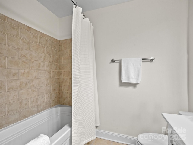 300 W 5th St Unit 433, Charlotte, NC 28202 - bathroom featuring toilet, shower / bath combo with shower curtain, tile patterned flooring, vanity, and baseboards