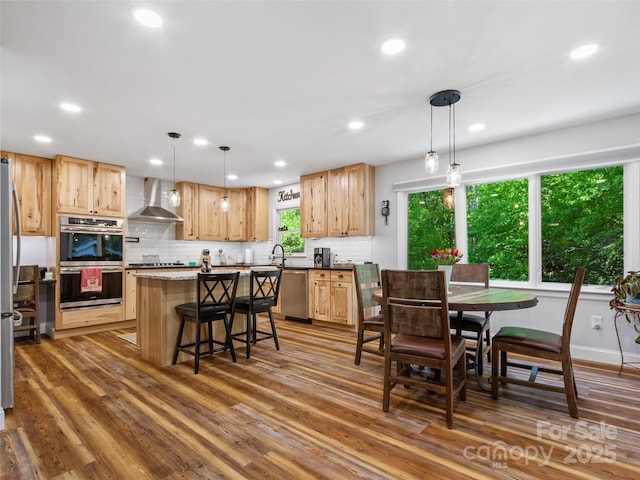1493 Upper Browns Creek Rd, Burnsville, NC 28714 - kitchen featuring wall chimney range hood, stainless steel appliances, recessed lighting, light brown cabinets, and tasteful backsplash