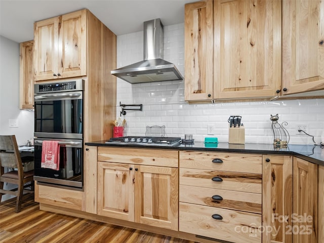 1493 Upper Browns Creek Rd, Burnsville, NC 28714 - kitchen with wall chimney exhaust hood, stainless steel appliances, dark countertops, and light brown cabinets