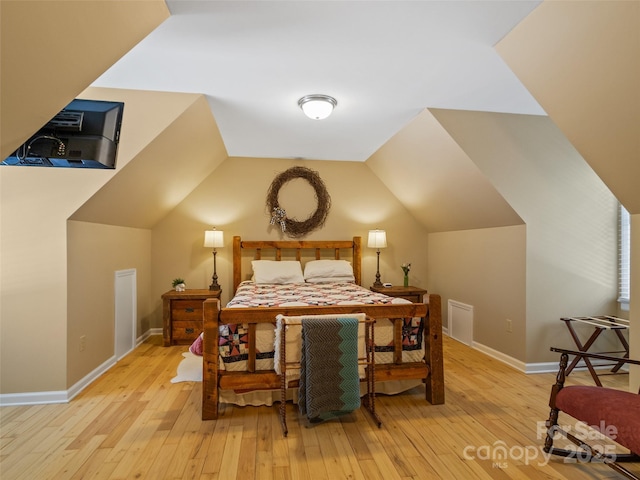 1493 Upper Browns Creek Rd, Burnsville, NC 28714 - bedroom featuring light wood finished floors, baseboards, and vaulted ceiling