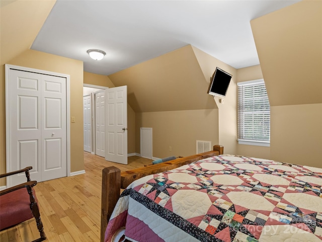1493 Upper Browns Creek Rd, Burnsville, NC 28714 - bedroom featuring light wood finished floors, lofted ceiling, baseboards, and a closet