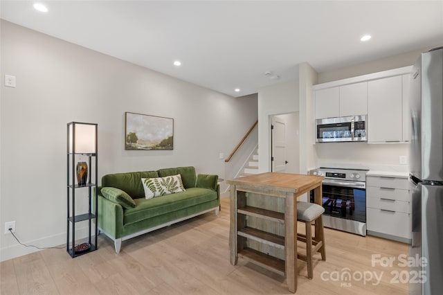 1081 Hicks Rd Unit B, Highlands, NC 28741 - kitchen featuring appliances with stainless steel finishes, light wood-style flooring, white cabinets, light countertops, and recessed lighting