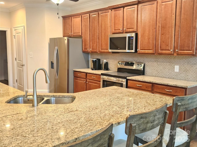 1108 Tarram Ct Unit 12, Lancaster, SC 29720 - kitchen with appliances with stainless steel finishes, a sink, a breakfast bar, crown molding, and light stone counters