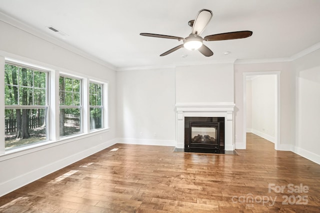 8521 Aspen Ct, Charlotte, NC 28227 - unfurnished living room featuring crown molding, hardwood / wood-style floors, a multi sided fireplace, a ceiling fan, and baseboards