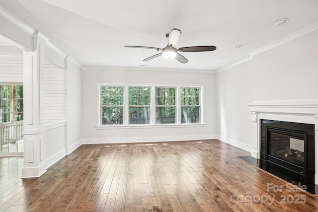 8521 Aspen Ct, Charlotte, NC 28227 - unfurnished living room featuring ceiling fan, a glass covered fireplace, wood-type flooring, crown molding, and baseboards