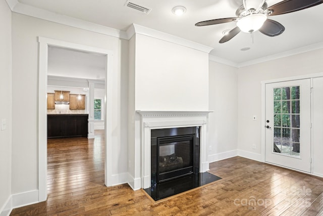 8521 Aspen Ct, Charlotte, NC 28227 - unfurnished living room featuring wood-type flooring, crown molding, a fireplace with flush hearth, a ceiling fan, and baseboards
