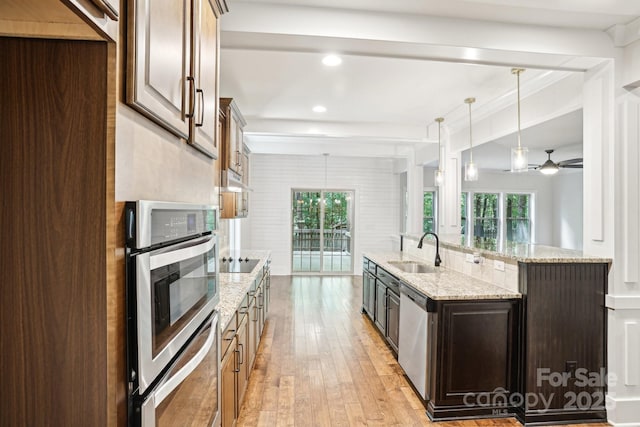 8521 Aspen Ct, Charlotte, NC 28227 - kitchen with a sink, appliances with stainless steel finishes, light wood-style flooring, plenty of natural light, and recessed lighting