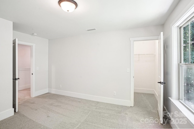 8521 Aspen Ct, Charlotte, NC 28227 - unfurnished bedroom with a spacious closet, carpet floors, baseboards, and a closet