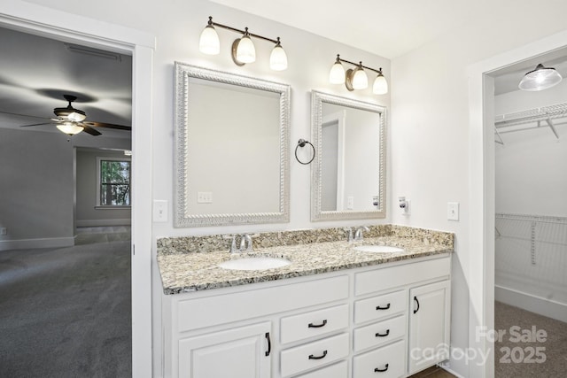 8521 Aspen Ct, Charlotte, NC 28227 - full bath with double vanity, a ceiling fan, baseboards, and a walk in closet