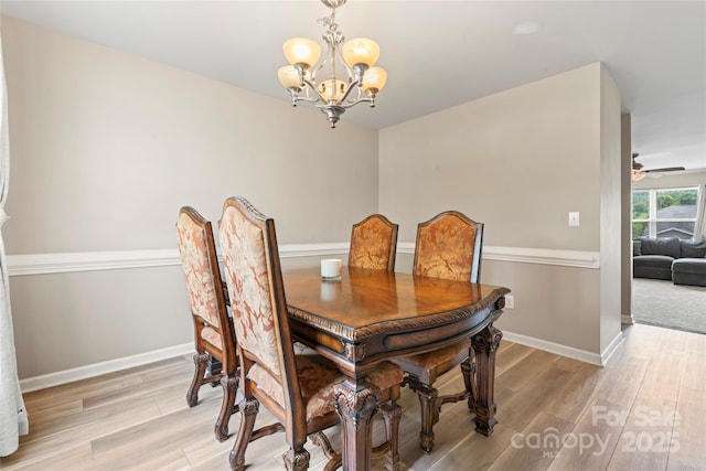 3996 Heather View Ln, Winston Salem, NC 27127 - dining area featuring a chandelier, light wood-type flooring, baseboards, and a ceiling fan