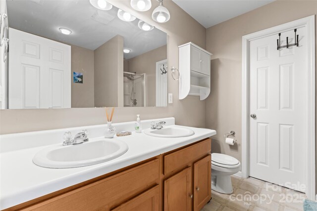 3996 Heather View Ln, Winston Salem, NC 27127 - bathroom with a stall shower, toilet, and double vanity