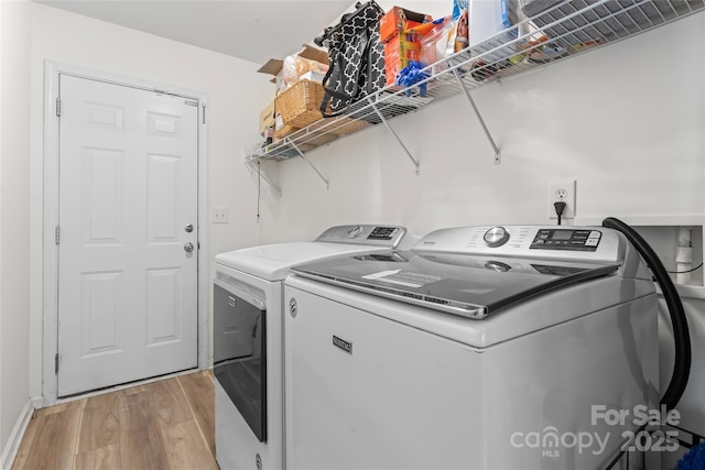 3996 Heather View Ln, Winston Salem, NC 27127 - washroom with light wood-type flooring, washer and dryer, and baseboards