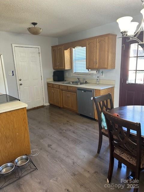 667 Blossom Hill Rd, Lincolnton, NC 28092 - kitchen with stainless steel dishwasher, a textured ceiling, dark wood-style flooring, brown cabinets, and light countertops