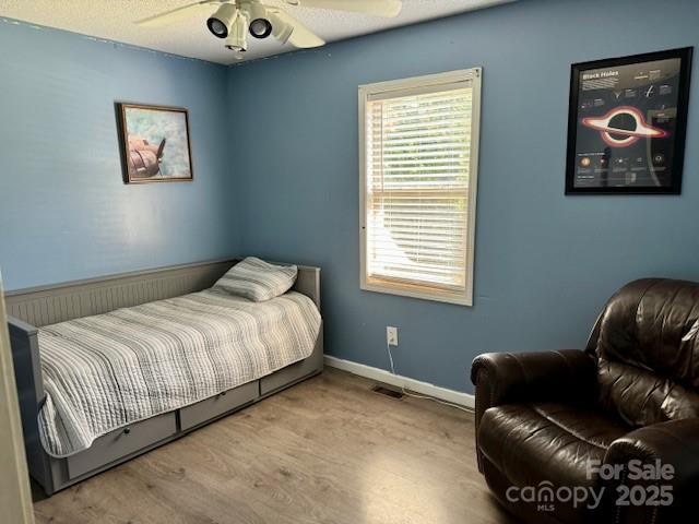 667 Blossom Hill Rd, Lincolnton, NC 28092 - bedroom with baseboards, a ceiling fan, and wood finished floors