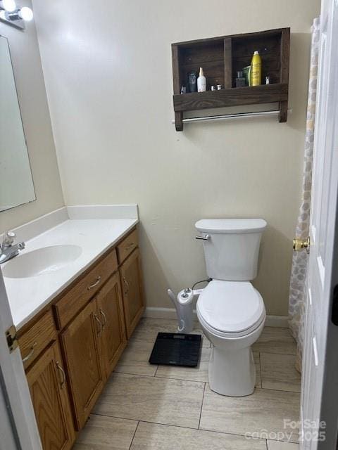 667 Blossom Hill Rd, Lincolnton, NC 28092 - bathroom with vanity, toilet, and baseboards