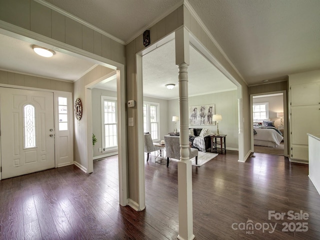 2666 Hill Ln, Gastonia, NC 28054 - entrance foyer with ornamental molding, ornate columns, plenty of natural light, dark wood finished floors, and baseboards