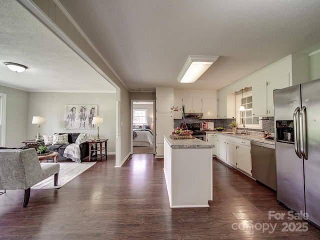 2666 Hill Ln, Gastonia, NC 28054 - kitchen with appliances with stainless steel finishes, a sink, white cabinetry, dark wood finished floors, and tasteful backsplash