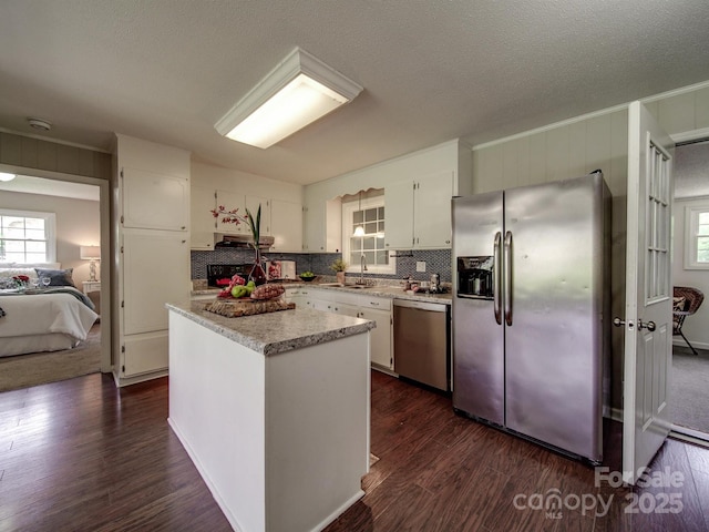 2666 Hill Ln, Gastonia, NC 28054 - kitchen with appliances with stainless steel finishes, white cabinets, healthy amount of natural light, dark wood-style flooring, and a textured ceiling