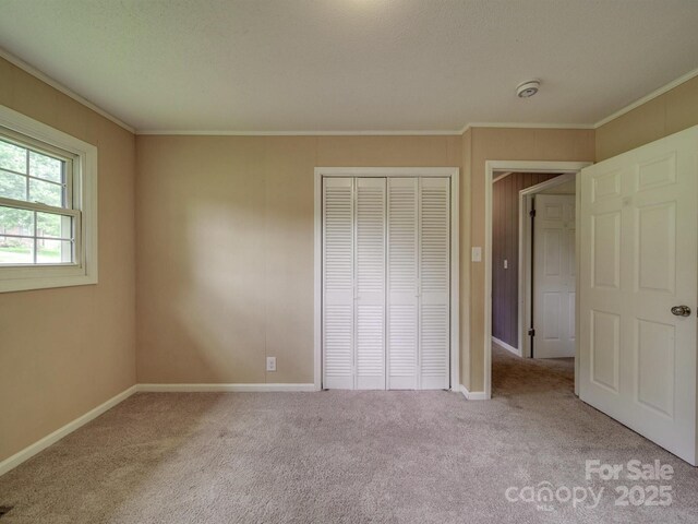 2666 Hill Ln, Gastonia, NC 28054 - unfurnished bedroom featuring carpet flooring, a closet, ornamental molding, and baseboards