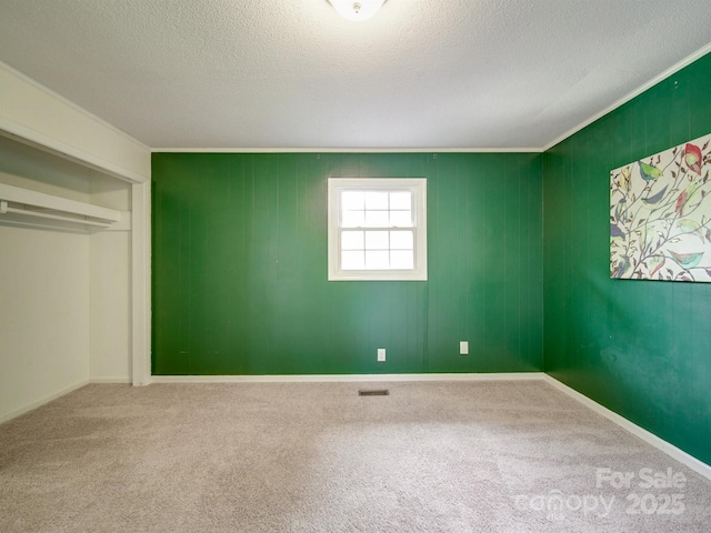 2666 Hill Ln, Gastonia, NC 28054 - unfurnished bedroom with carpet flooring, a textured ceiling, crown molding, and a closet