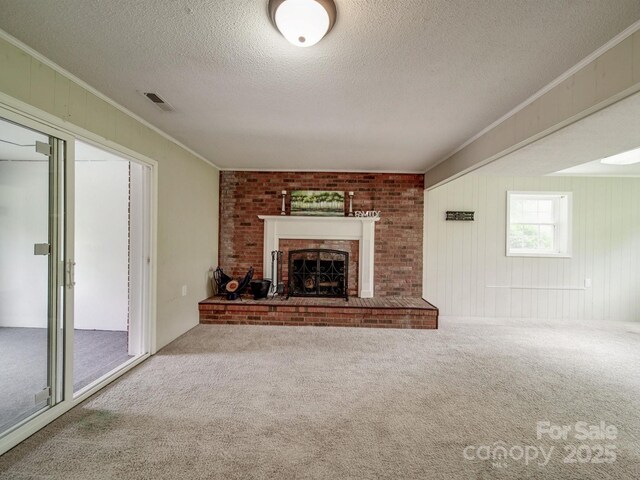 2666 Hill Ln, Gastonia, NC 28054 - unfurnished living room with ornamental molding, carpet flooring, a fireplace, and a textured ceiling