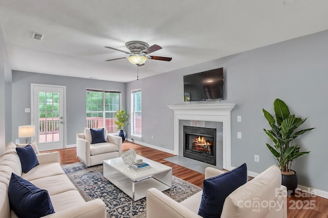 8120 Vermilion Dr, Charlotte, NC 28215 - living room featuring wood finished floors, a fireplace, baseboards, and a ceiling fan