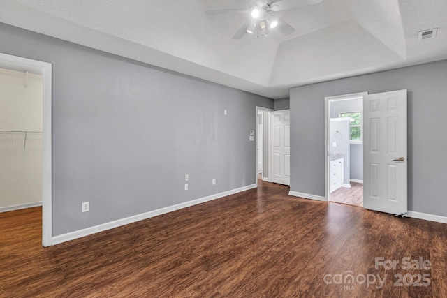 8120 Vermilion Dr, Charlotte, NC 28215 - unfurnished bedroom featuring wood finished floors, baseboards, a walk in closet, ceiling fan, and a closet