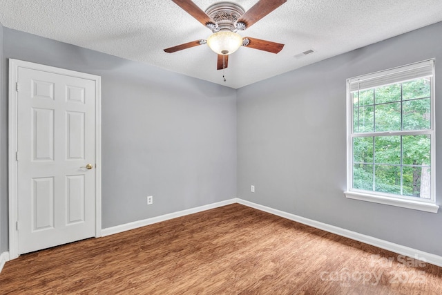 8120 Vermilion Dr, Charlotte, NC 28215 - unfurnished room featuring wood finished floors, baseboards, a ceiling fan, and a textured ceiling