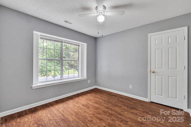 8120 Vermilion Dr, Charlotte, NC 28215 - unfurnished room with dark wood-type flooring, a textured ceiling, a ceiling fan, and baseboards