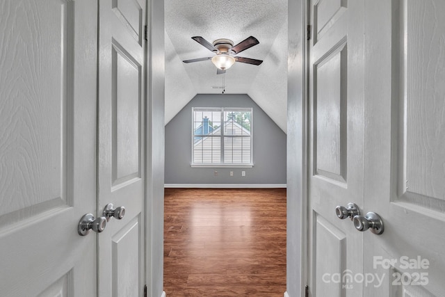 8120 Vermilion Dr, Charlotte, NC 28215 - bonus room featuring a textured ceiling, lofted ceiling, wood finished floors, ceiling fan, and baseboards