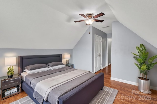 8120 Vermilion Dr, Charlotte, NC 28215 - bedroom with lofted ceiling, wood finished floors, a ceiling fan, and baseboards