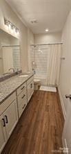 320 Lawrence Gray Rd, Charlotte, NC 28262 - full bathroom featuring vanity, a shower, wood finished floors, and toilet