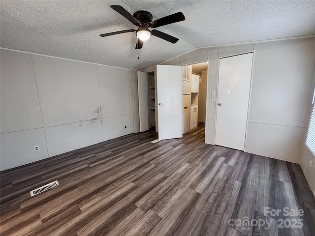 1145 Daniel Rd, Mocksville, NC 27028 - unfurnished bedroom featuring dark wood finished floors, a textured ceiling, lofted ceiling, and a ceiling fan