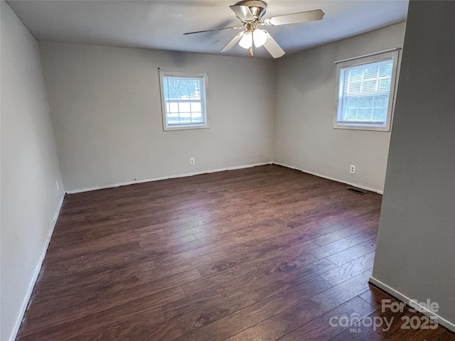 1145 Daniel Rd, Mocksville, NC 27028 - empty room with wood finished floors, a ceiling fan, and baseboards
