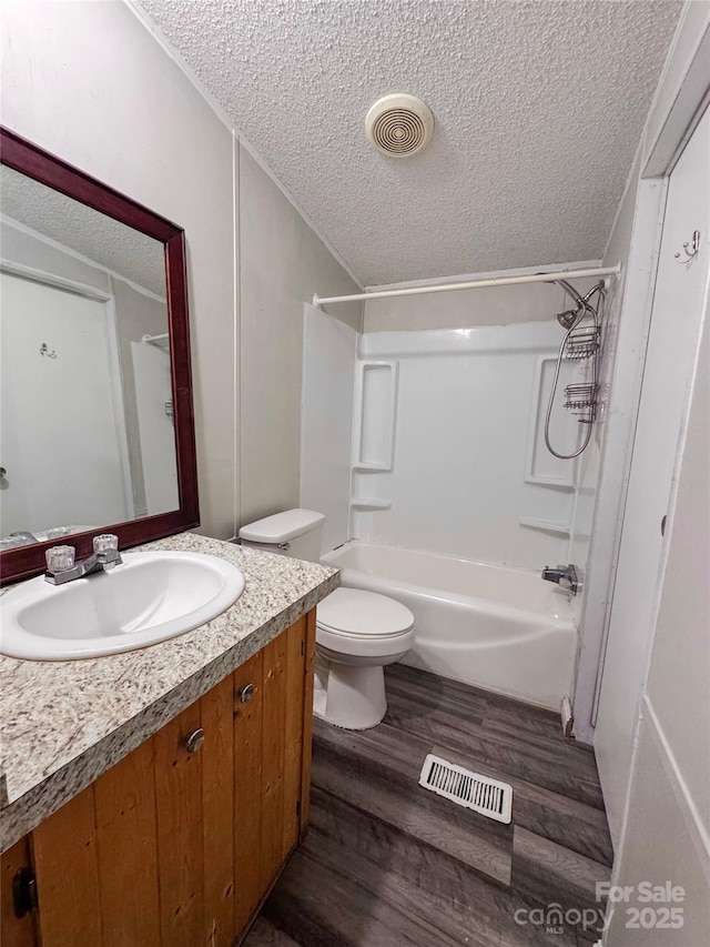 1145 Daniel Rd, Mocksville, NC 27028 - full bath featuring a textured ceiling, wood finished floors, vanity, bathing tub / shower combination, and toilet