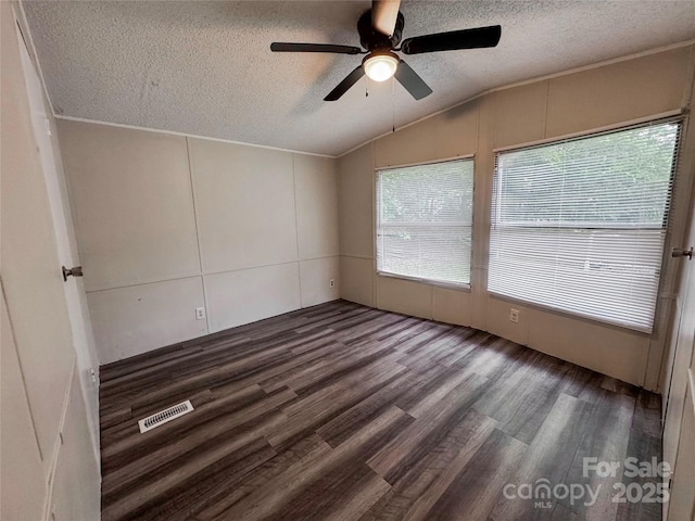 1145 Daniel Rd, Mocksville, NC 27028 - unfurnished room featuring a textured ceiling, lofted ceiling, a ceiling fan, and wood finished floors