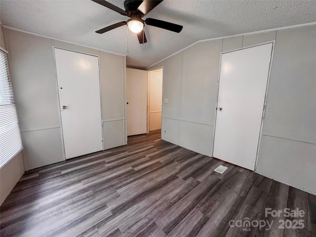 1145 Daniel Rd, Mocksville, NC 27028 - unfurnished bedroom with wood finished floors, a textured ceiling, a closet, vaulted ceiling, and a ceiling fan