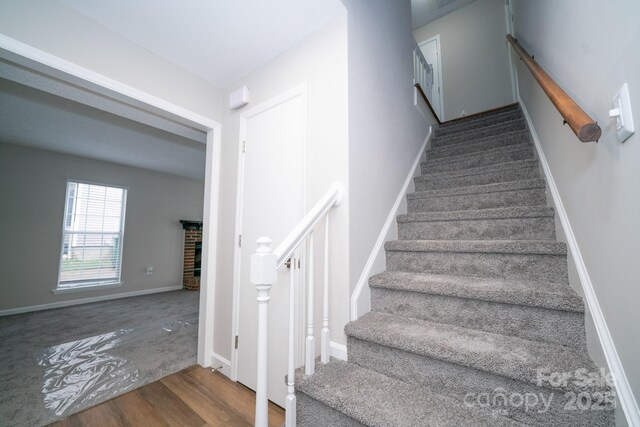 8125 Sheringham Way, Charlotte, NC 28227 - stairs featuring wood finished floors and a fireplace