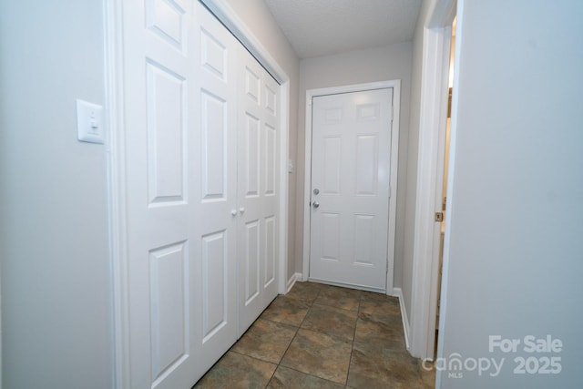 8125 Sheringham Way, Charlotte, NC 28227 - corridor featuring baseboards, dark stone finish flooring, and a textured ceiling