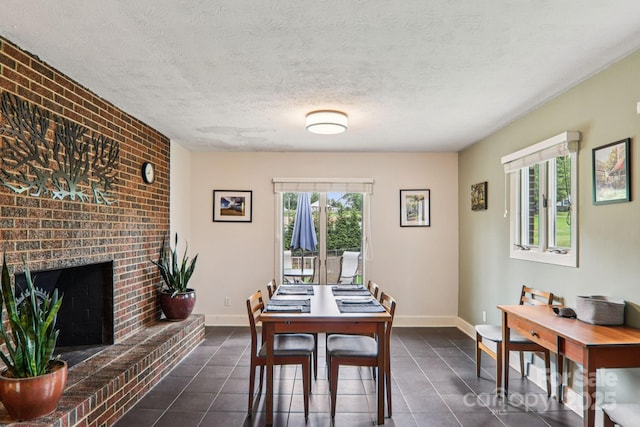318 Old Leicester Hwy, Asheville, NC 28806 - dining space with dark tile patterned flooring, a fireplace, and a textured ceiling