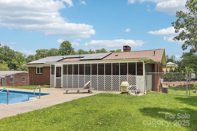 318 Old Leicester Hwy, Asheville, NC 28806 - back of house with a sunroom, roof mounted solar panels, a patio area, a chimney, and a gate