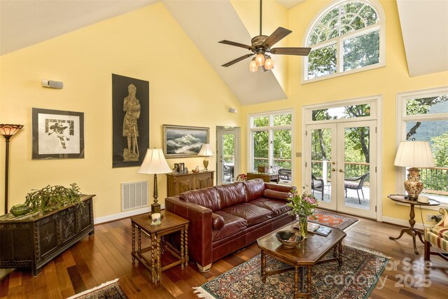 25 Windsong Dr, Fairview, NC 28730 - living room featuring high vaulted ceiling, healthy amount of natural light, hardwood / wood-style floors, ceiling fan, and baseboards