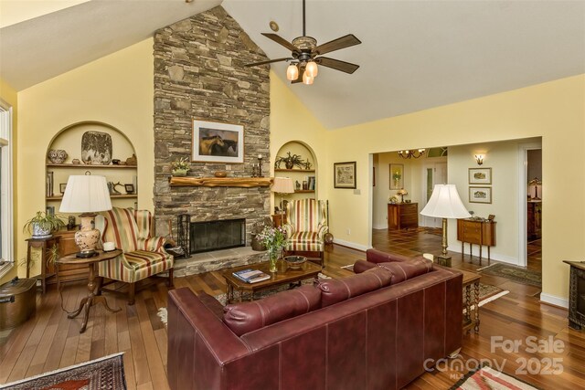 25 Windsong Dr, Fairview, NC 28730 - living room with wood-type flooring, ceiling fan, a stone fireplace, high vaulted ceiling, and baseboards