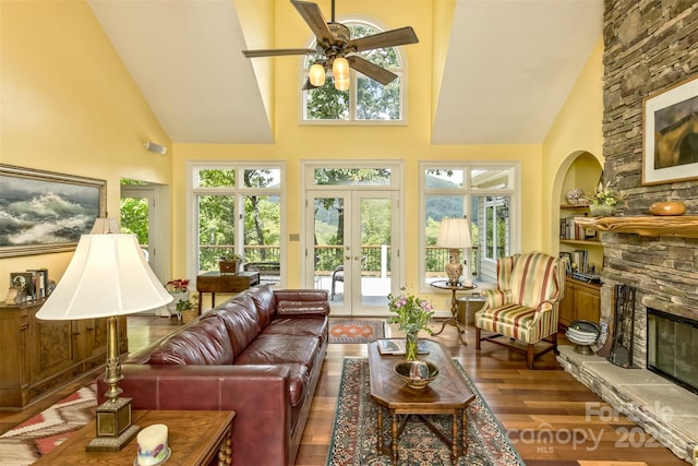 25 Windsong Dr, Fairview, NC 28730 - living area featuring a fireplace, high vaulted ceiling, wood finished floors, a ceiling fan, and french doors