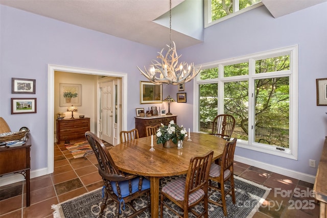 25 Windsong Dr, Fairview, NC 28730 - dining space with a chandelier, dark tile patterned floors, and baseboards